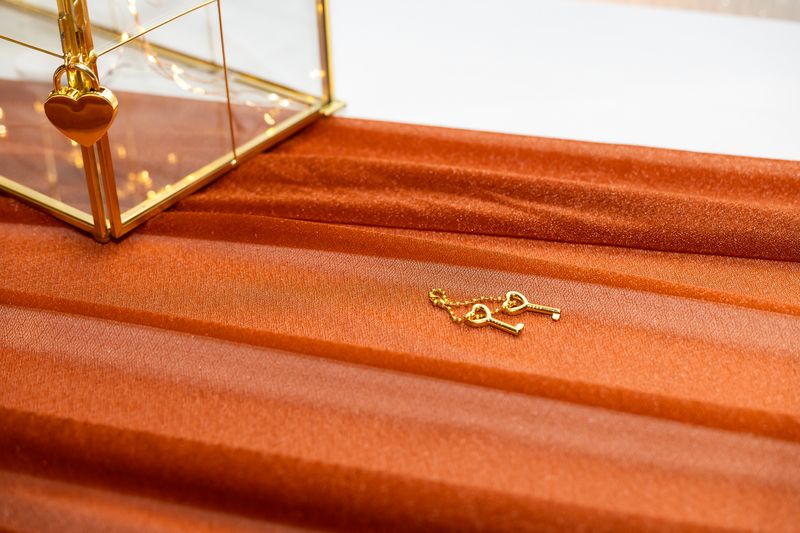 Gold key detail on burnt orange table runner
