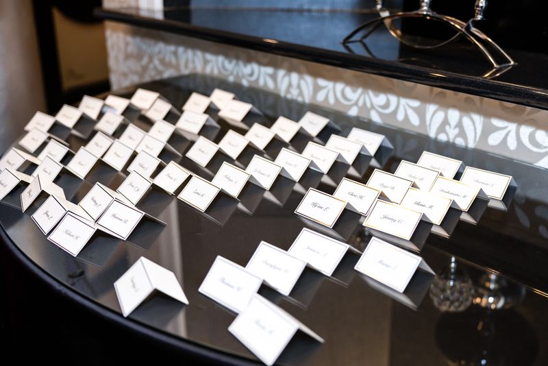 Handwritten place cards on a mirrored display