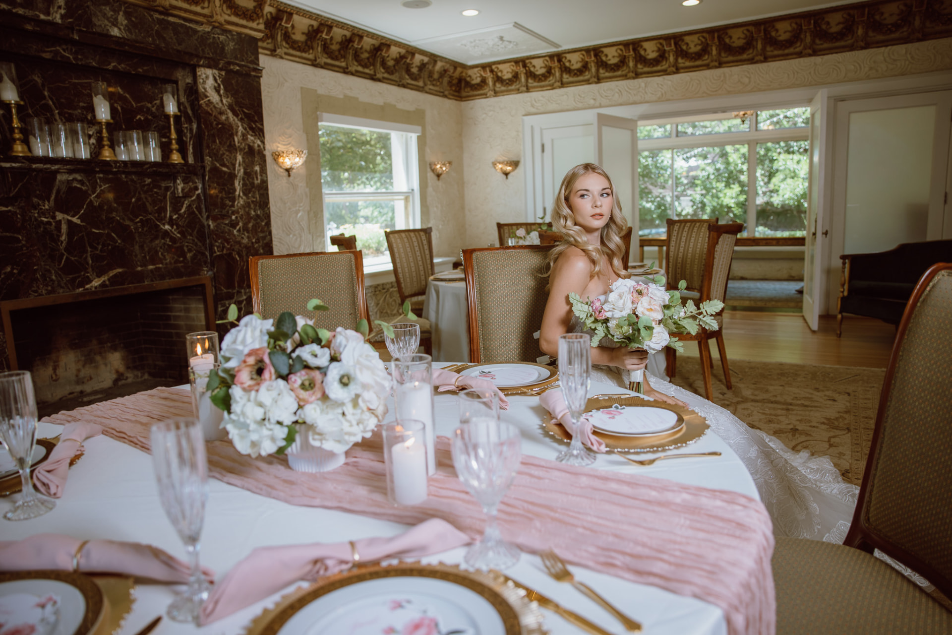 Bride at the head table with white and blush florals