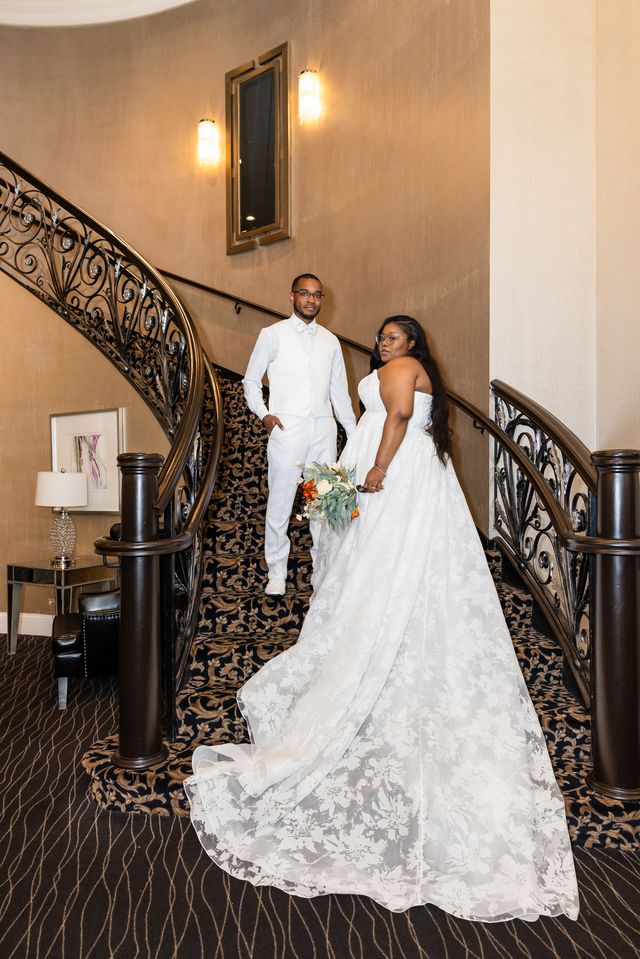 Bride and groom on the grand staircase at The Seville