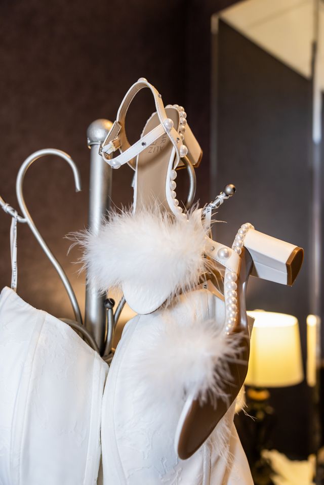 Bridal gown and pearl feather heels on display