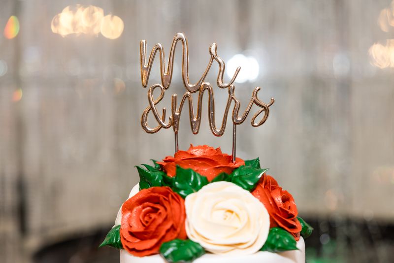 Mr & Mrs cake topper over red and cream roses