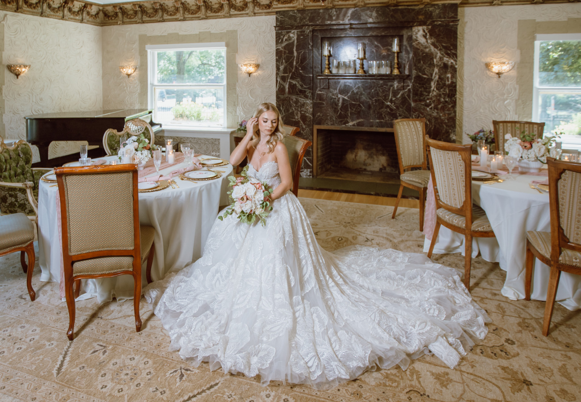 Bridal portrait with the gown train spread before the marble fireplace