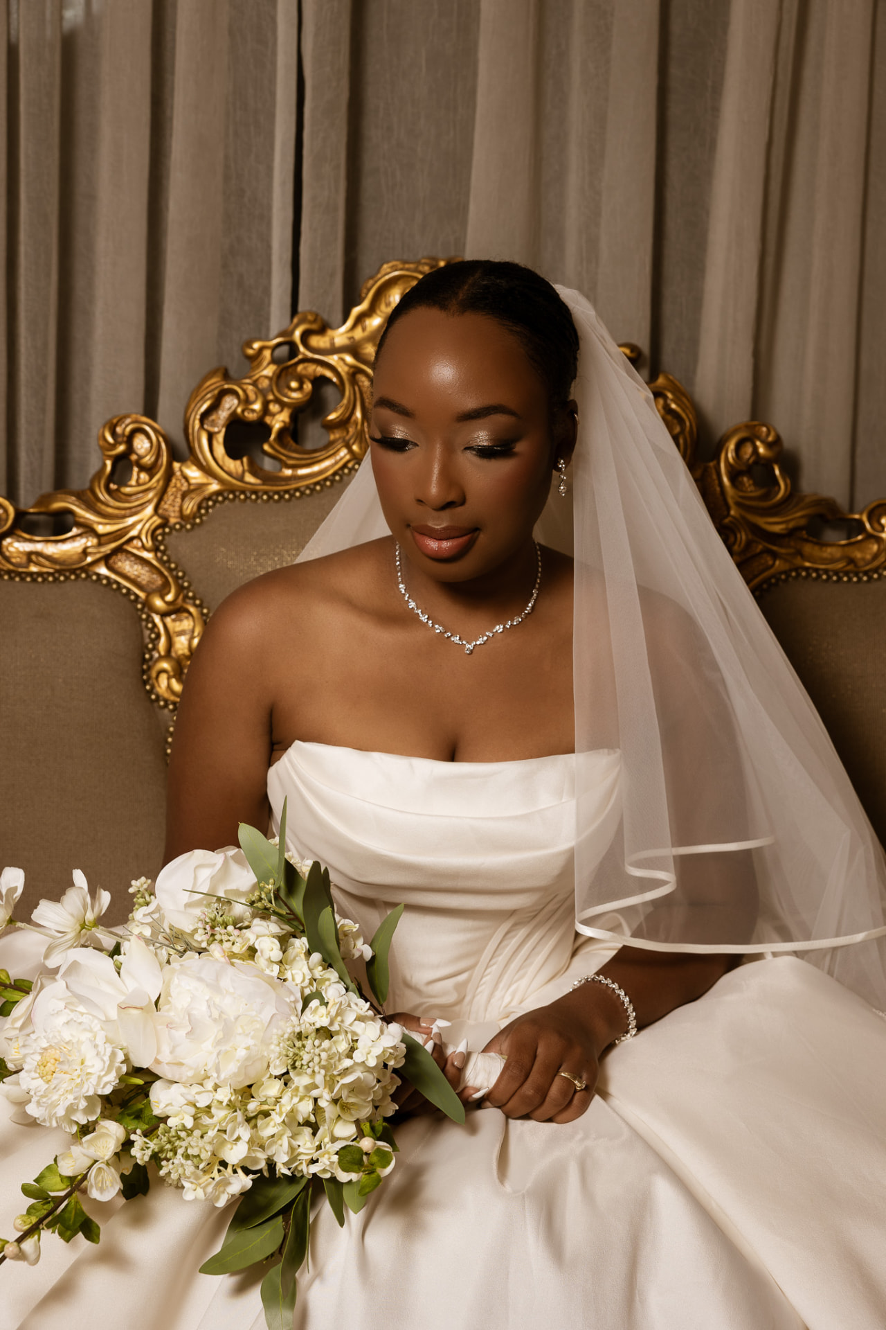 Bridal portrait seated on a gold baroque settee