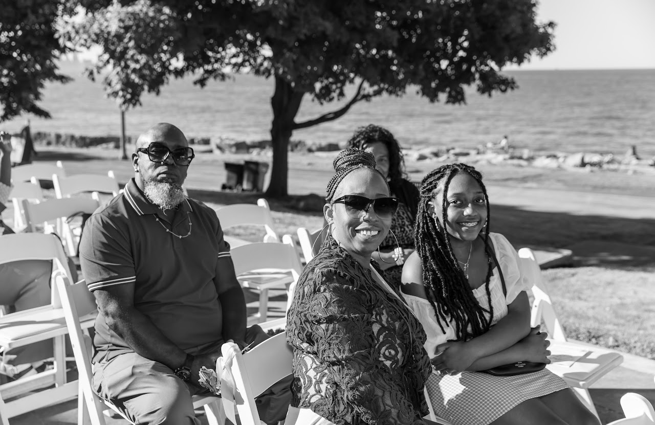Family seated at the lakeside ceremony, black and white