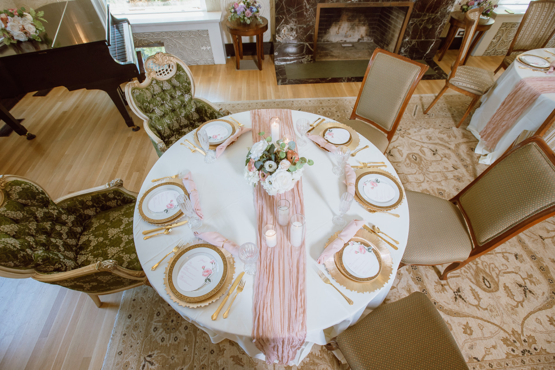 Overhead view of a round table with blush runner and white florals