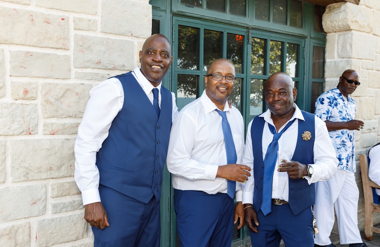 Groomsmen in blue outside the fieldhouse